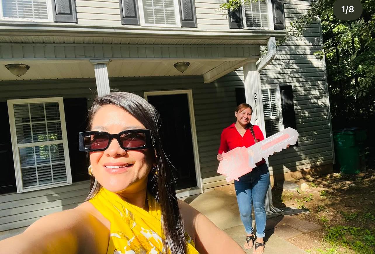 Sandy Alvear with client celebrating sold home